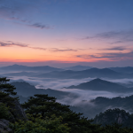동트기 직전 동쪽 하늘의 분홍빛 여명과 산 능선, 안개 낀 계곡 및 소나무 실루엣을 표현한 AI 생성 이미지